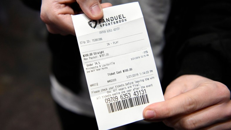 Dan Schiavone of Englewood shows his ticket after betting on the Louisville/Minnesota game on the first day of the NCAA basketball tournament at the Meadowlands Racetrack on Thursday, March 21, 2019 in East Rutherford. This is the first year sports fans can legally place bets during March Madness in New Jersey. 

Meadowlands March Madness Gambling