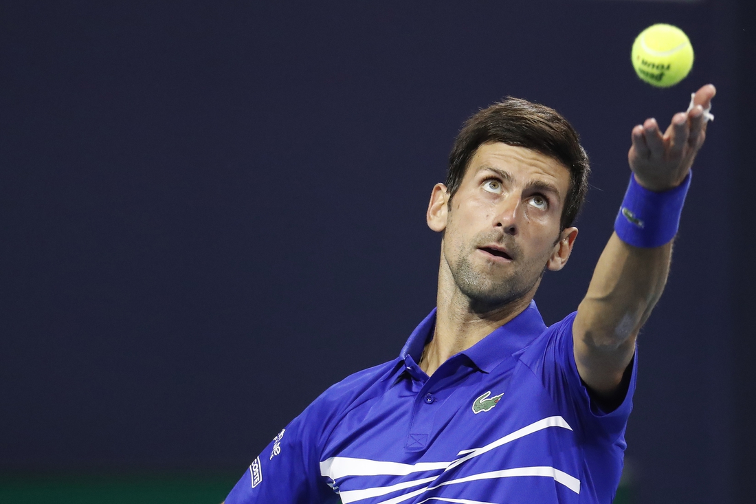 Mar 22, 2019; Miami Gardens, FL, USA; Novak Djokovic of Serbia serves against Bernard Tomic of Australia (not pictured) in the second round of the Miami Open at Miami Open Tennis Complex. Mandatory Credit: Geoff Burke-USA TODAY Sports