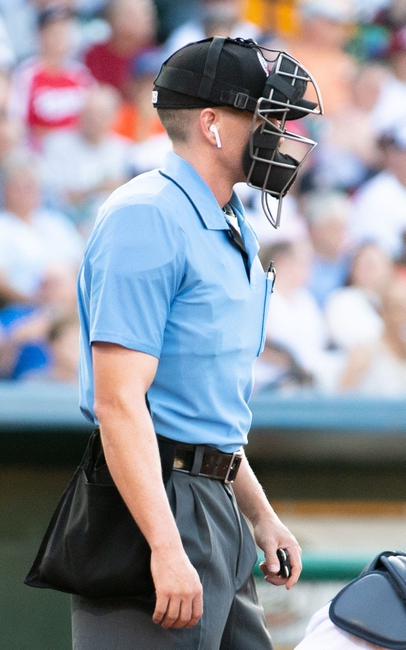 The umpire wears an ear piece to hear the call determined by the TrackMan radar system, July 10, 2019.

Ydr Cc 7 10 19 Trackman