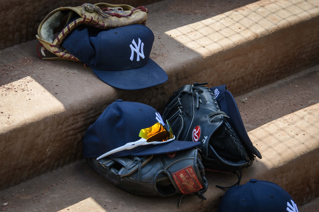 Sep 29, 2019; Arlington, TX, USA; A view of a New York Yankees cap and glove and logo during the game between the Rangers and the Yankees in the final home game at Globe Life Park in Arlington. Mandatory Credit: Jerome Miron-USA TODAY Sports