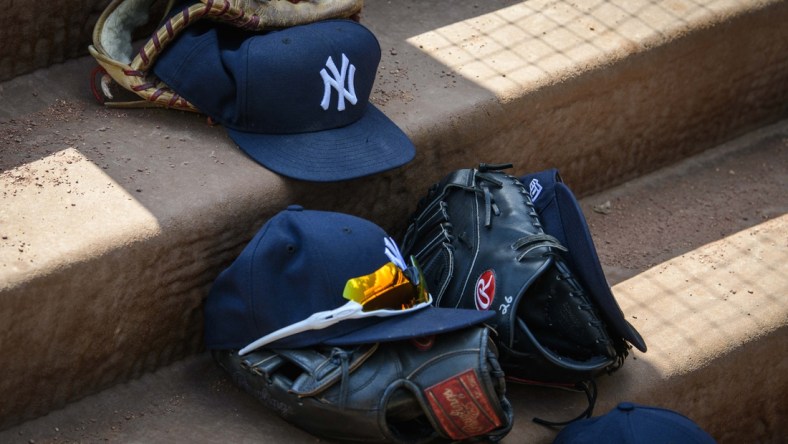 Sep 29, 2019; Arlington, TX, USA; A view of a New York Yankees cap and glove and logo during the game between the Rangers and the Yankees in the final home game at Globe Life Park in Arlington. Mandatory Credit: Jerome Miron-USA TODAY Sports