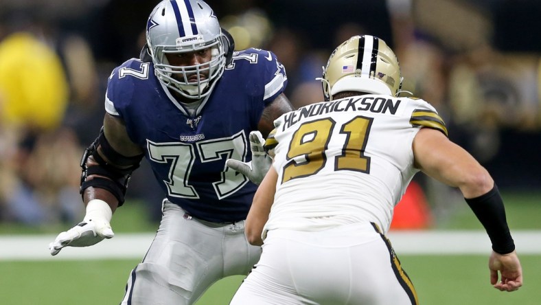 Sep 29, 2019; New Orleans, LA, USA; Dallas Cowboys offensive tackle Tyron Smith (77) blocks New Orleans Saints defensive end Trey Hendrickson (91) in the first quarter at the Mercedes-Benz Superdome. Mandatory Credit: Chuck Cook-USA TODAY Sports