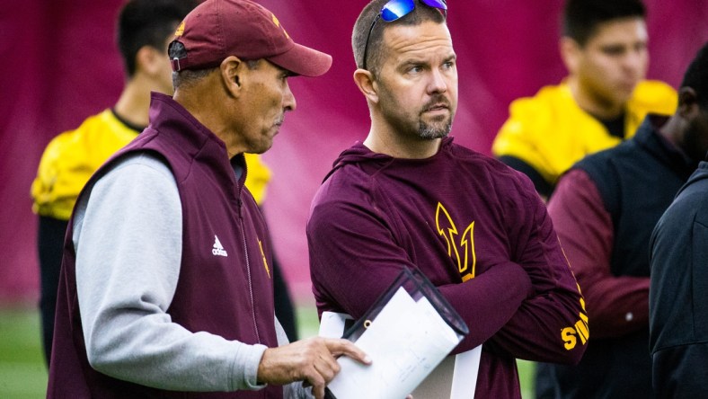 Arizona State University head football coach Herm Edwards speaks with newly hired offensive coordinator Zak Hill during practice at the Verde Dickey Dome on campus in Tempe, Tuesday, December 17, 2019.

Asu Football