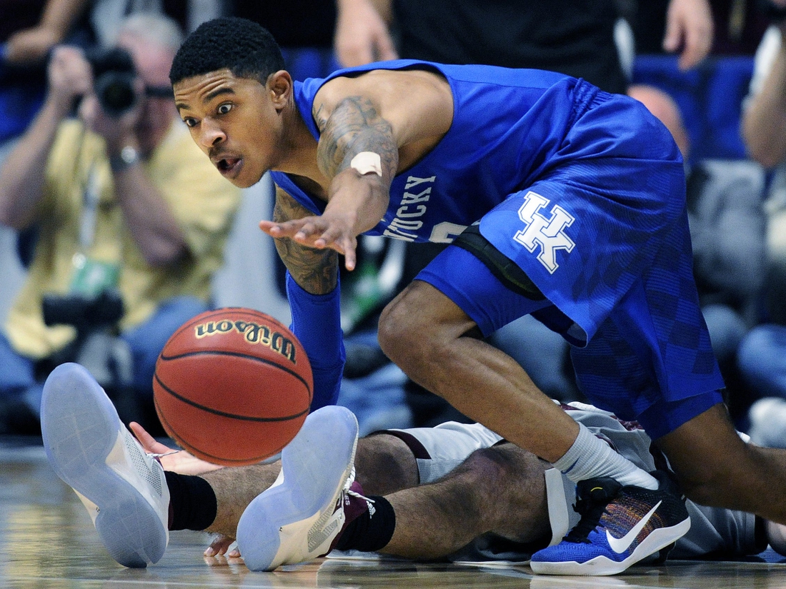 Kentucky guard Tyler Ulis (3) dives over Texas A&M Aggies guard Alex Caruso (21) for the ball during the second half of the SEC Men's Basketball Tournament championship game at Bridgestone Arena March 13, 2016 in Nashville.

Nas Sec 031316 A004