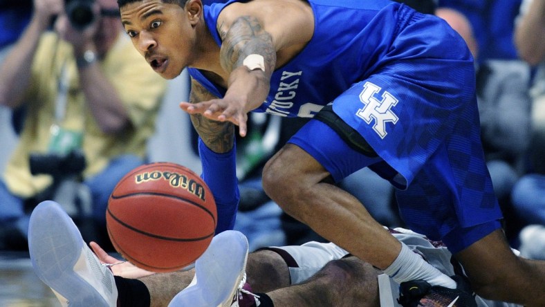 Kentucky guard Tyler Ulis (3) dives over Texas A&M Aggies guard Alex Caruso (21) for the ball during the second half of the SEC Men's Basketball Tournament championship game at Bridgestone Arena March 13, 2016 in Nashville.

Nas Sec 031316 A004