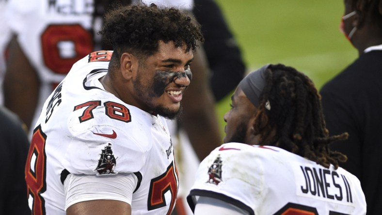 Nov 15, 2020; Charlotte, North Carolina, USA; Tampa Bay Buccaneers offensive tackle Tristan Wirfs (78) talks to running back Ronald Jones (27) on the sidelines in the third quarter at Bank of America Stadium. Mandatory Credit: Bob Donnan-USA TODAY Sports