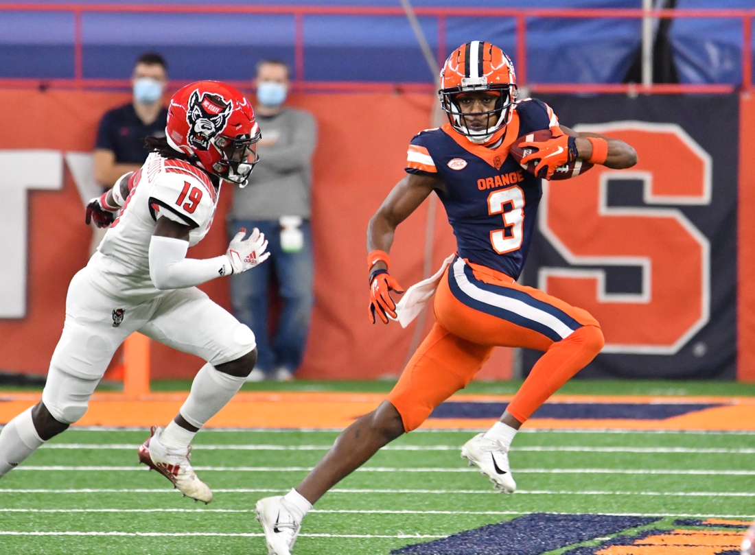 Nov 28, 2020; Syracuse, New York, USA; Syracuse Orange wide receiver Taj Harris (3) runs from North Carolina State Wolfpack defensive back Joshua Pierre-Louis (19) after making a catch in the second quarter at the Carrier Dome. Mandatory Credit: Mark Konezny-USA TODAY Sports