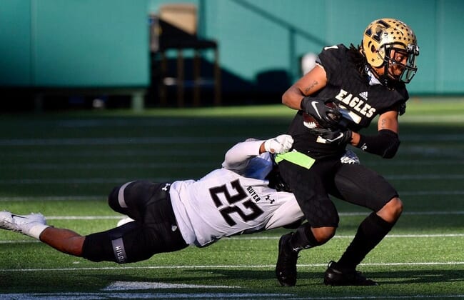 Abilene High receiver Frederick Johnson (7) tries to break a tackle of Denton Guyer's Peyton Bowen (22) during the first half of Saturday's Region I-6A Division II semifinal at Globe Life Park in Arlington.Ahs Fb Dguyer Halftime