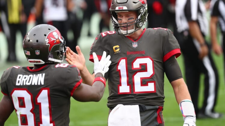 Jan 3, 2021; Tampa, Florida, USA; Tampa Bay Buccaneers quarterback Tom Brady (12) smiles with wide receiver Antonio Brown (81) after he scored a touchdown against the Atlanta Falcons during the second half at Raymond James Stadium. Mandatory Credit: Kim Klement-USA TODAY Sports