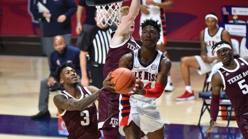 Jan 23, 2021; Oxford, Mississippi, USA; Mississippi Rebels guard Jarkel Joiner (24) lays the ball up against Texas A&M Aggies guard Quenton Jackson (3) during the second half at The Pavilion at Ole Miss. Mandatory Credit: Justin Ford-USA TODAY Sports