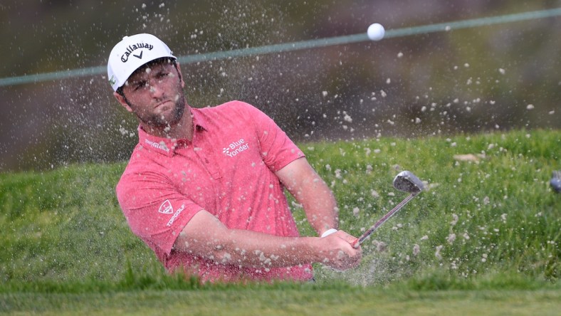 Jan 31, 2021; San Diego, California, USA; Jon Rahm plays a shot from a bunker on the 11th hole during the final round of the Farmers Insurance Open golf tournament at Torrey Pines Municipal Golf Course - South Course. Mandatory Credit: Orlando Ramirez-USA TODAY Sports