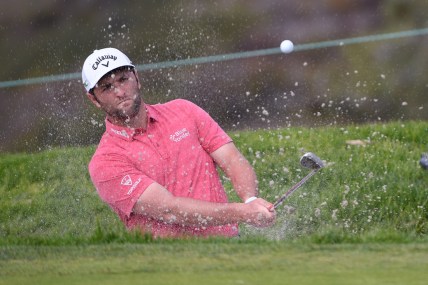 Jan 31, 2021; San Diego, California, USA; Jon Rahm plays a shot from a bunker on the 11th hole during the final round of the Farmers Insurance Open golf tournament at Torrey Pines Municipal Golf Course - South Course. Mandatory Credit: Orlando Ramirez-USA TODAY Sports