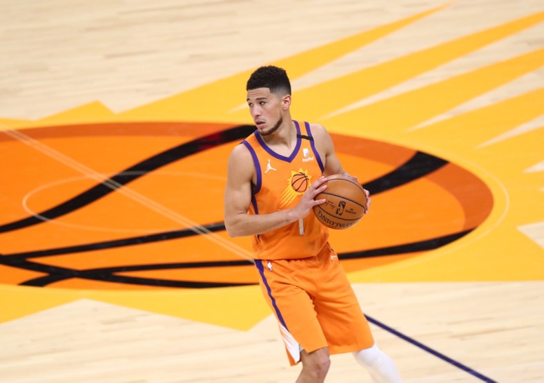 Feb 5, 2021; Phoenix, Arizona, USA; Phoenix Suns guard Devin Booker (1) against the Detroit Pistons at Phoenix Suns Arena. Mandatory Credit: Mark J. Rebilas-USA TODAY Sports