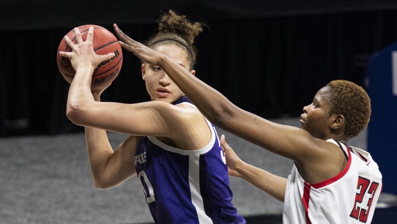 Mar 11, 2021; MO, Kansas City, USA; Kansas State Wildcats center Ayoka Lee (50) controls the ball against Texas Tech Lady Raiders center Khadija Faye (23) in the second half at Municipal Auditorium. Mandatory Credit: Amy Kontras-USA TODAY Sports