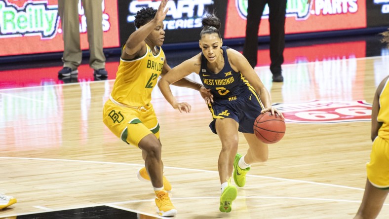 Mar 14, 2021; Kansas City, Missouri, USA; West Virginia Mountaineers guard Kysre Gondrezick (2) dribbles by Baylor Lady Bears guard Moon Ursin (12) in the second half at Municipal Auditorium. Mandatory Credit: Amy Kontras-USA TODAY Sports