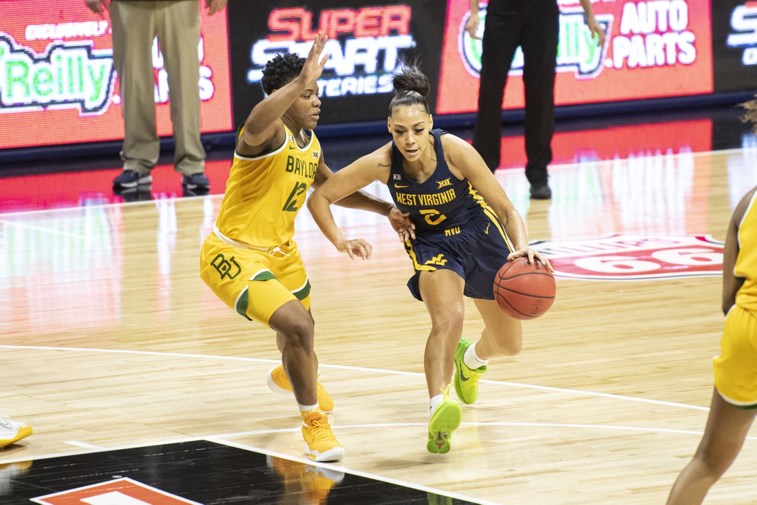 Mar 14, 2021; Kansas City, Missouri, USA; West Virginia Mountaineers guard Kysre Gondrezick (2) dribbles by Baylor Lady Bears guard Moon Ursin (12) in the second half at Municipal Auditorium. Mandatory Credit: Amy Kontras-USA TODAY Sports