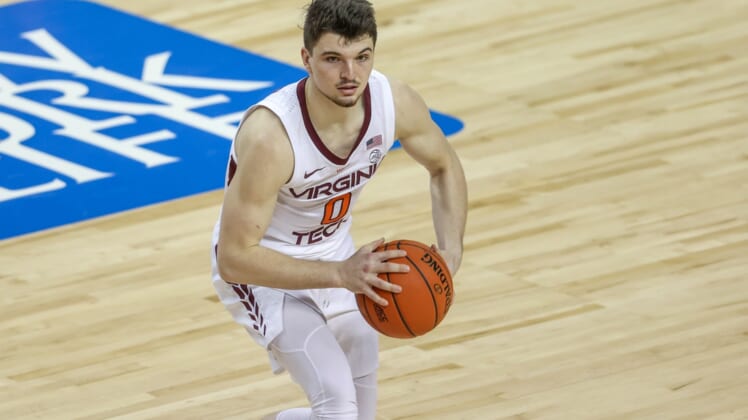 Mar 11, 2021; Greensboro, North Carolina, USA; Virginia Tech Hokies guard Hunter Cattoor (0) looks to pass against the North Carolina Tar Heels in the quarterfinal round of the 2021 ACC tournament at Greensboro Coliseum. The North Carolina Tar Heels won 81-73. Mandatory Credit: Nell Redmond-USA TODAY Sports