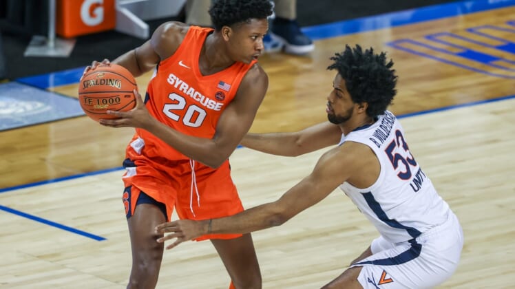 Mar 11, 2021; Greensboro, North Carolina, USA; Syracuse Orange forward Robert Braswell (20) looks to pass against Virginia Cavaliers guard Tomas Woldetensae (53) in the quarterfinal round of the 2021 ACC tournament at Greensboro Coliseum. The Virginia Cavaliers won 72-69.  Mandatory Credit: Nell Redmond-USA TODAY Sports