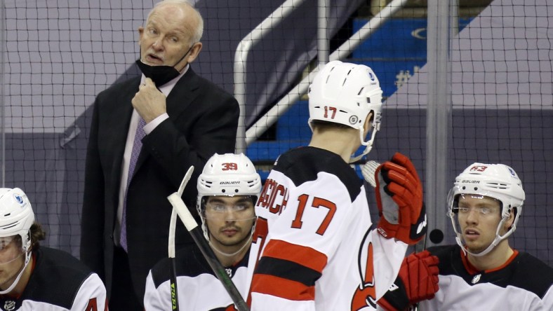 Mar 21, 2021; Pittsburgh, Pennsylvania, USA;  New Jersey Devils head coach Lindy Ruff (left) talks to center Yegor Sharangovich (17) against the Pittsburgh Penguins during the second period at PPG Paints Arena. New Jersey won 2-1 in overtime. Mandatory Credit: Charles LeClaire-USA TODAY Sports