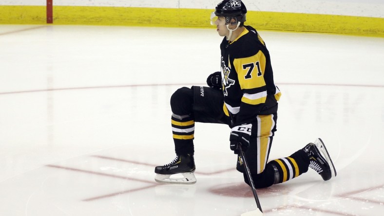 May 8, 2021; Pittsburgh, Pennsylvania, USA;  Pittsburgh Penguins center Evgeni Malkin (71) stretches on the ice before playing the Buffalo Sabres at PPG Paints Arena. Mandatory Credit: Charles LeClaire-USA TODAY Sports