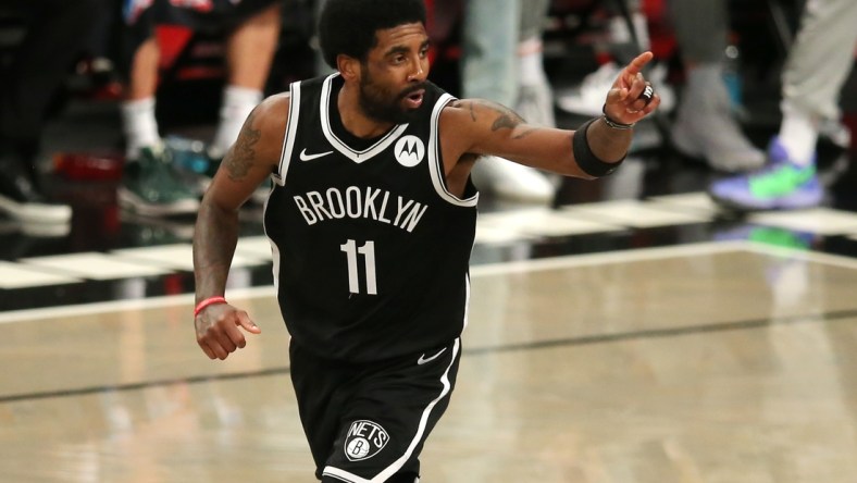 Jun 5, 2021; Brooklyn, New York, USA; Brooklyn Nets point guard Kyrie Irving (11) reacts after making a basket against the Milwaukee Bucks during the second quarter of game one in the Eastern Conference semifinals of the 2021 NBA Playoffs at Barclays Center. Mandatory Credit: Brad Penner-USA TODAY Sports