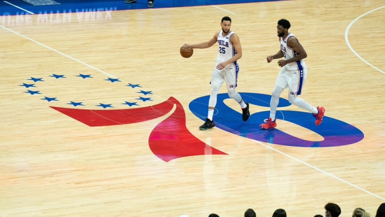 Jun 20, 2021; Philadelphia, Pennsylvania, USA; Philadelphia 76ers guard Ben Simmons (25) and center Joel Embiid (21) bring the ball up court against the Atlanta Hawks during the second quarter of game seven of the second round of the 2021 NBA Playoffs at Wells Fargo Center. Mandatory Credit: Bill Streicher-USA TODAY Sports