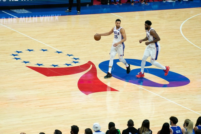 Jun 20, 2021; Philadelphia, Pennsylvania, USA; Philadelphia 76ers guard Ben Simmons (25) and center Joel Embiid (21) bring the ball up court against the Atlanta Hawks during the second quarter of game seven of the second round of the 2021 NBA Playoffs at Wells Fargo Center. Mandatory Credit: Bill Streicher-USA TODAY Sports