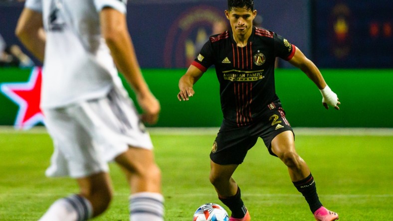 Jul 3, 2021; Chicago, Illinois, USA; Atlanta United defender Ronald Hernandez (2) dribbles the ball against the Chicago Fire during the second half at Soldier Field. Mandatory Credit: Jon Durr-USA TODAY Sports