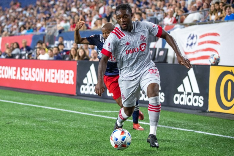 Jul 7, 2021; Foxborough, Massachusetts, USA; Toronto FC forward Ayo Akinola (20) possesses the ball during the first half against the New England Revolution at Gillette Stadium. Mandatory Credit: Paul Rutherford-USA TODAY Sports