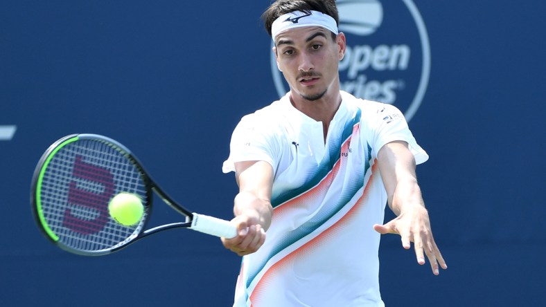 Aug 9, 2021; Toronto, Ontario, Canada; Lorenzo Sonego of Italy plays a shot against Ugo Humbert of France in first round play at Aviva Centre. Mandatory Credit: Dan Hamilton-USA TODAY Sports