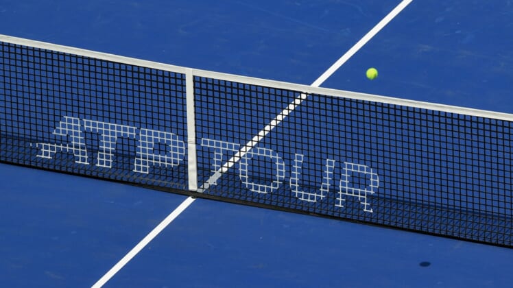 Aug 14, 2021; Mason, OH, USA; A view of the ATP Tour logo on the Center Court net as an official ball is in play during the Western and Southern Open tennis tournament at Lindner Family Tennis Center. Mandatory Credit: Aaron Doster-USA TODAY Sports