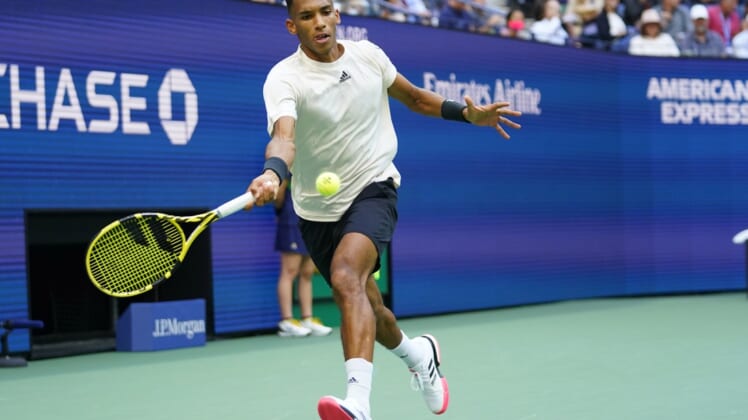 Sep 10, 2021; Flushing, NY, USA; Felix Auger-Aliassime of Canada hits a forehand against Daniil Medvedev of Russia (not pictured) on day twelve of the 2021 U.S. Open tennis tournament at USTA Billie Jean King National Tennis Center. Mandatory Credit: Danielle Parhizkaran-USA TODAY Sports