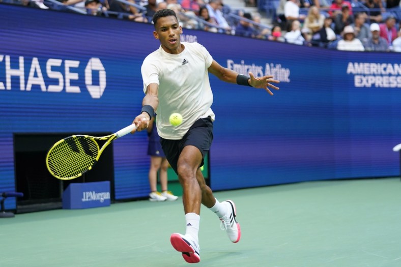 Sep 10, 2021; Flushing, NY, USA; Felix Auger-Aliassime of Canada hits a forehand against Daniil Medvedev of Russia (not pictured) on day twelve of the 2021 U.S. Open tennis tournament at USTA Billie Jean King National Tennis Center. Mandatory Credit: Danielle Parhizkaran-USA TODAY Sports