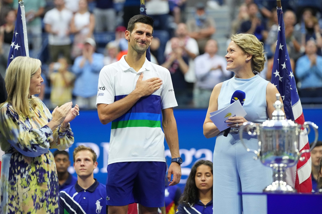 Sep 12, 2021; Flushing, NY, USA; Novak Djokovic of Serbia  (M) acknowledges the crowd during an interview with ESPN hist Chris McKendry (R) during the trophy ceremony after his match against Daniil Medvedev of Russia (not pictured) in the men's singles final on day fourteen of the 2021 U.S. Open tennis tournament at USTA Billie Jean King National Tennis Center. Mandatory Credit: Danielle Parhizkaran-USA TODAY Sports