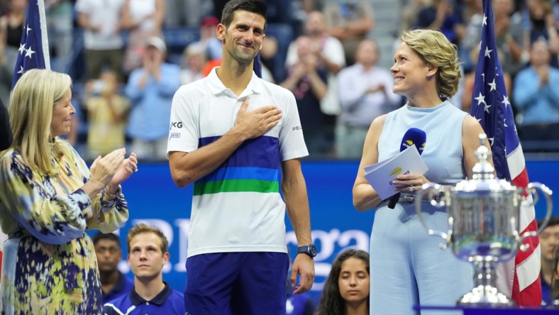 Sep 12, 2021; Flushing, NY, USA; Novak Djokovic of Serbia  (M) acknowledges the crowd during an interview with ESPN hist Chris McKendry (R) during the trophy ceremony after his match against Daniil Medvedev of Russia (not pictured) in the men's singles final on day fourteen of the 2021 U.S. Open tennis tournament at USTA Billie Jean King National Tennis Center. Mandatory Credit: Danielle Parhizkaran-USA TODAY Sports