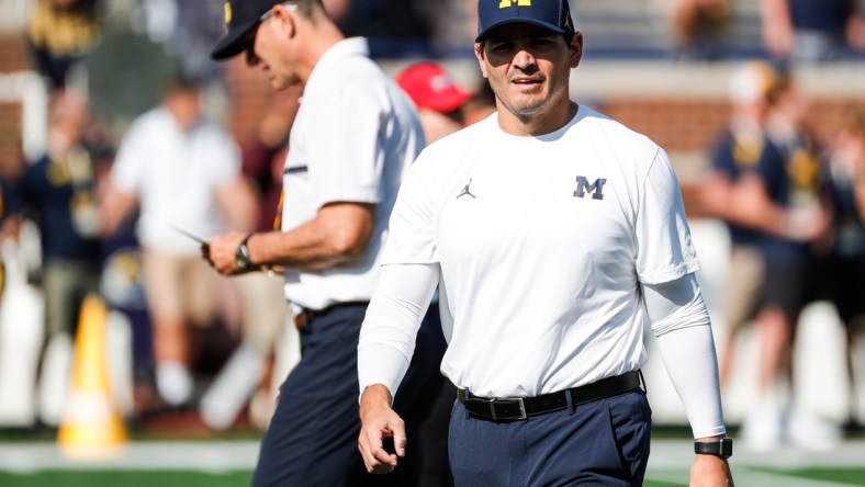 Michigan defensive coordinator Mike Macdonald watches warm up before a game against Northern Illinois at Michigan Stadium in Ann Arbor on Saturday, Sept. 18, 2021.