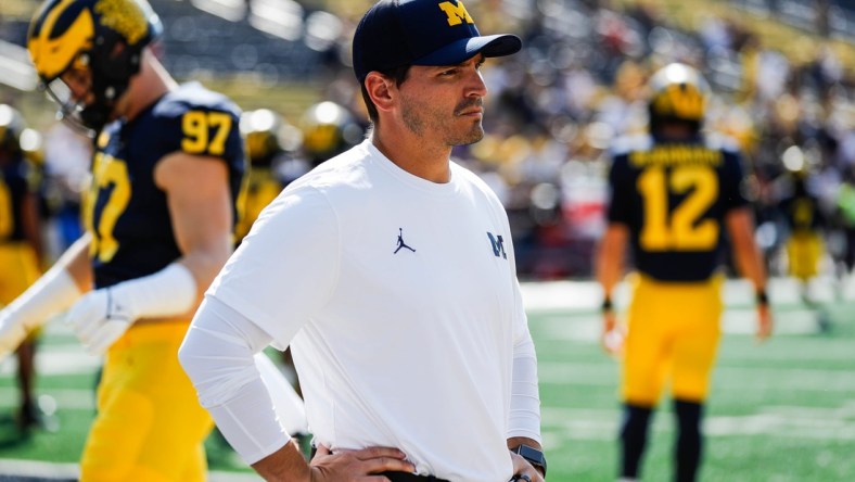 Michigan defensive coordinator Mike Macdonald watches warmups before a game against Northern Illinois at Michigan Stadium in Ann Arbor on Saturday, Sept. 18, 2021.