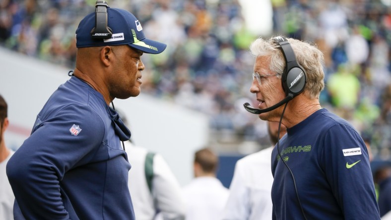 Sep 19, 2021; Seattle, Washington, USA; Seattle Seahawks head coach Pete Carroll, right, talks with defensive coordinator Ken Norton, Jr., left, during the fourth quarter against the Tennessee Titans at Lumen Field. Mandatory Credit: Joe Nicholson-USA TODAY Sports