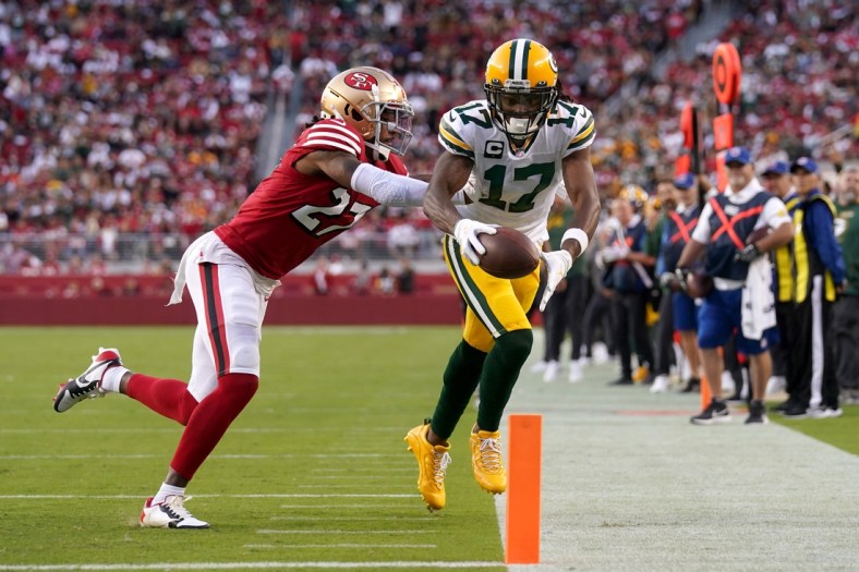 Sep 26, 2021; Santa Clara, California, USA; Green Bay Packers wide receiver Davante Adams (17) is tackled short of the end zone by San Francisco 49ers defensive back Dontae Johnson (27) after making a catch in the second quarter at Levi's Stadium. Mandatory Credit: Cary Edmondson-USA TODAY Sports