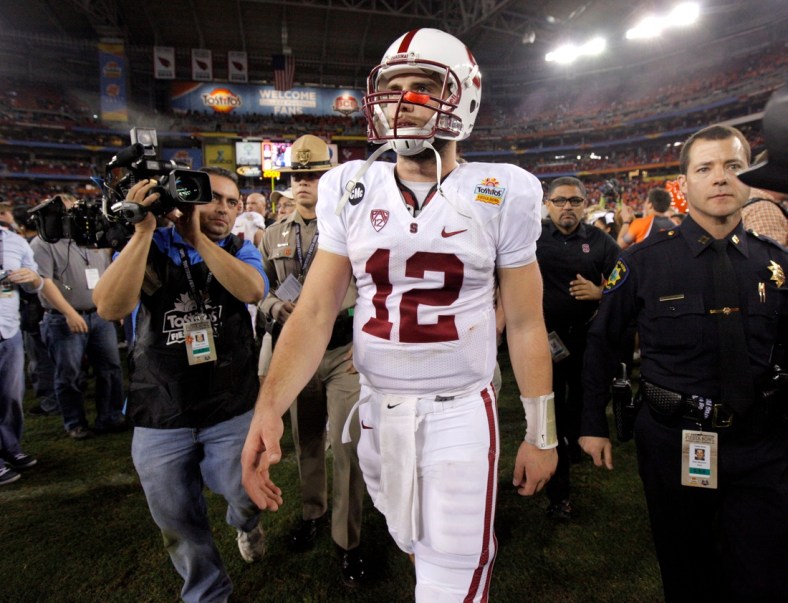Stanford's Andrew Luck (12) walks of the field after losing the Fiesta Bowl between the Oklahoma State University Cowboys (OSU) and the Stanford Cardinal at the University of Phoenix Stadium in Glendale, Ariz., Tuesday, Jan. 3, 2012.

Osu101