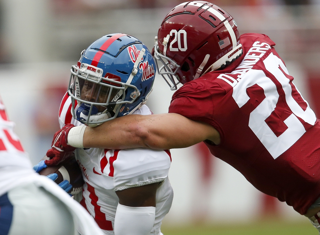 Oct 2, 2021; Tuscaloosa, Alabama, USA;  Alabama linebacker Drew Sanders (20) wraps up Ole Miss wide receiver Dontario Drummond (11) at Bryant-Denny Stadium. Mandatory Credit: Gary Cosby-USA TODAY Sports