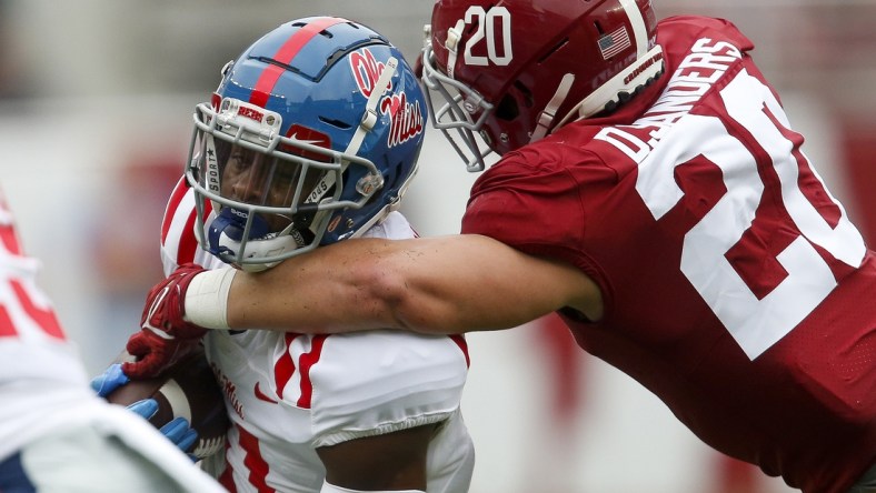 Oct 2, 2021; Tuscaloosa, Alabama, USA;  Alabama linebacker Drew Sanders (20) wraps up Ole Miss wide receiver Dontario Drummond (11) at Bryant-Denny Stadium. Mandatory Credit: Gary Cosby-USA TODAY Sports