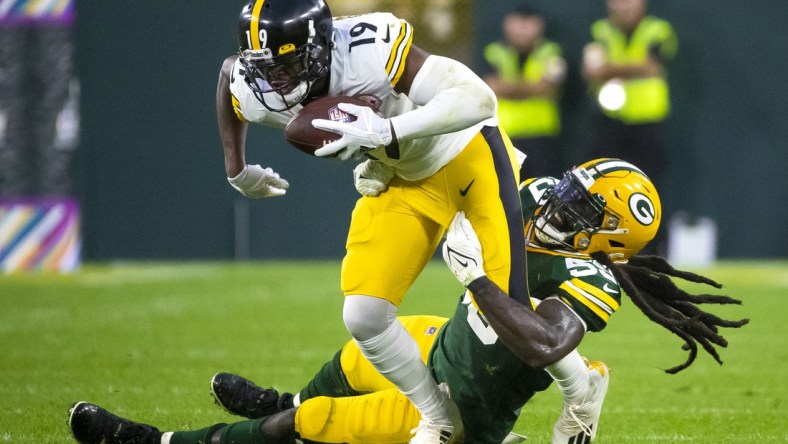 October 3, 2021; Green Bay, Wisconsin, USA; Green Bay Packers outside linebacker De'Vondre Campbell (59) tackles Pittsburgh Steelers wide receiver JuJu Smith-Schuster (19) in the fourth quarter at Lambeau Field. Mandatory Credit: Samantha Madar/Green Bay Press Gazette via USA TODAY NETWORK