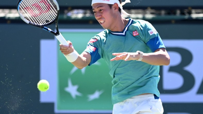 Oct 9, 2021; Indian Wells, CA, USA;  Kei Nishikori (JPN) hits a shot during his second round match against Daniel Evans (GER) during the BNP Paribas Open at the Indian Wells Tennis Garden. Mandatory Credit: Jayne Kamin-Oncea-USA TODAY Sports