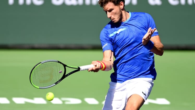 Oct 12, 2021; Indian Wells, CA, USA; Pablo Carreno Busta (ESP) hits a shot against Karen Khachanov (RUS) during a fourth round match in the BNP Paribas Open at the Indian Wells Tennis Garden. Mandatory Credit: Jayne Kamin-Oncea-USA TODAY Sports