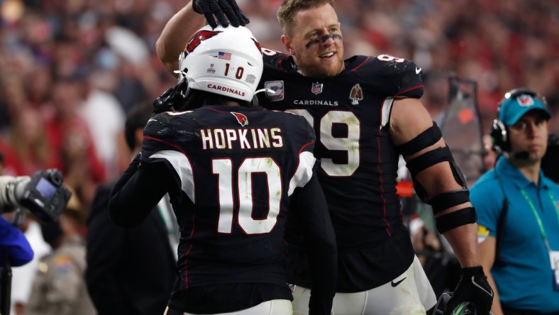 Oct 10, 2021; Glendale, Arizona, USA; Arizona Cardinals defensive end J.J. Watt (99) reacts with wide receiver DeAndre Hopkins (10) after Hopkins scored a fourth quarter touchdown against the San Francisco 49ers at State Farm Stadium. Mandatory Credit: Chris Coduto-USA TODAY Sports