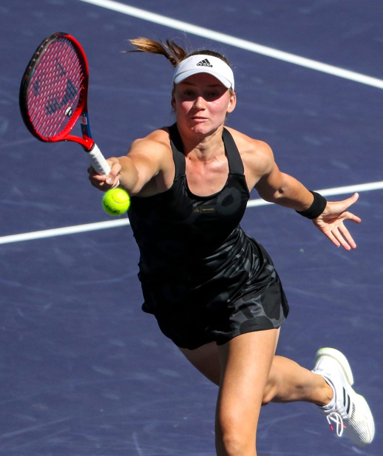 Elena Rybakina of Kazakhstan returns while playing against Su-Wei Hsieh of Taiwan and Elise Mertens of Belgium with doubles partner Veronika Kudermetova of Russia during the women's doubles final of the BNP Paribas Open at the Indian Wells Tennis Garden, Saturday, Oct. 16, 2021, in Indian Wells, Calif.