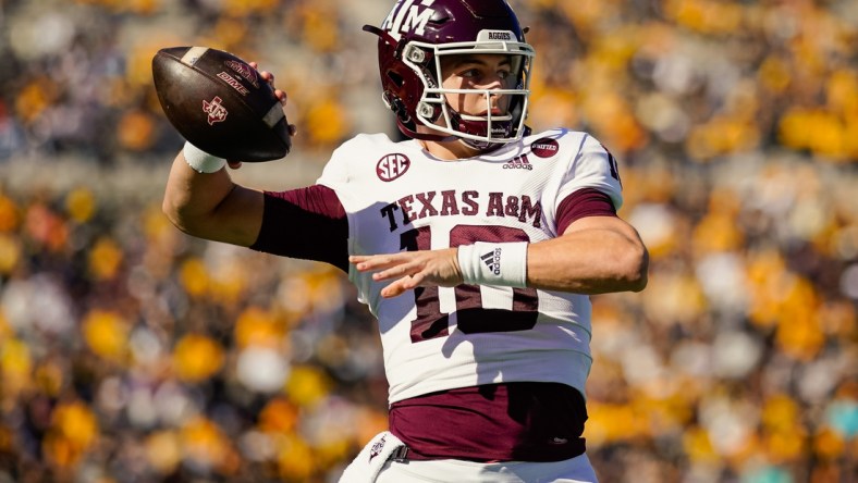 Oct 16, 2021; Columbia, Missouri, USA; Texas A&M Aggies quarterback Zach Calzada (10) warms up during a timeout in the first half against the Missouri Tigers at Faurot Field at Memorial Stadium. Mandatory Credit: Jay Biggerstaff-USA TODAY Sports