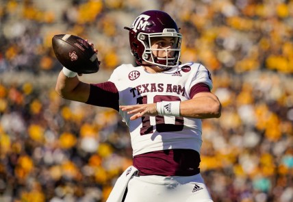 Oct 16, 2021; Columbia, Missouri, USA; Texas A&M Aggies quarterback Zach Calzada (10) warms up during a timeout in the first half against the Missouri Tigers at Faurot Field at Memorial Stadium. Mandatory Credit: Jay Biggerstaff-USA TODAY Sports
