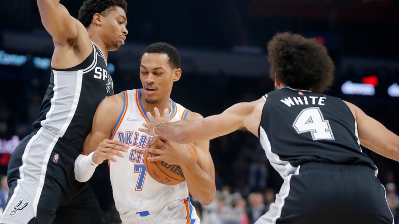 Oklahoma City's Darius Bazley (7) tries to drive to the basket between San Antonio's Keldon Johnson (3) and Derrick White (4) on Sunday night at Paycom Center.

bazley2